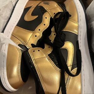 Black and gold Nike Air Jordan 1